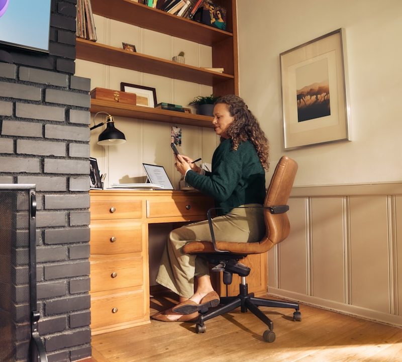 Woman working at a desk in a cozy home office.