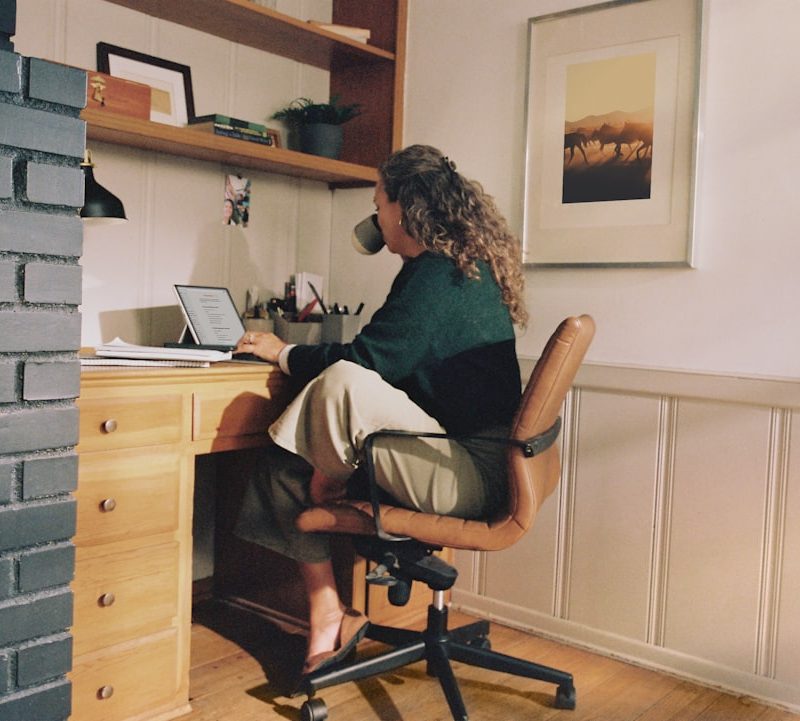 Woman working at desk with coffee