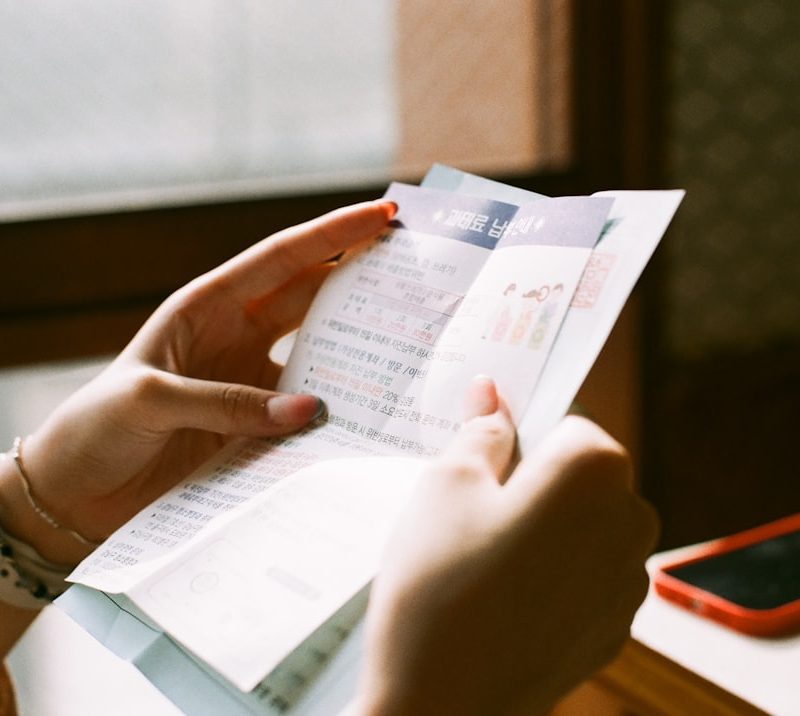 person holding white printer paper